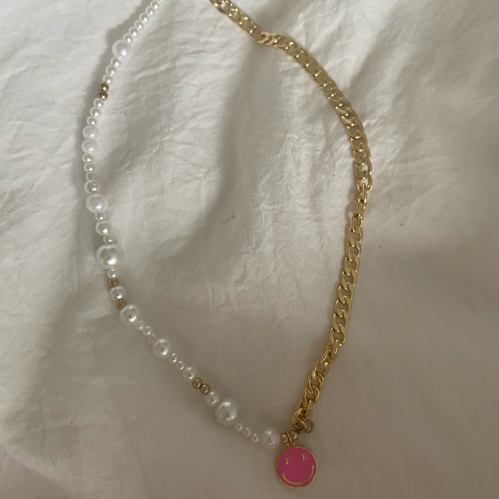 Pearl and gold necklace with pink smiley face